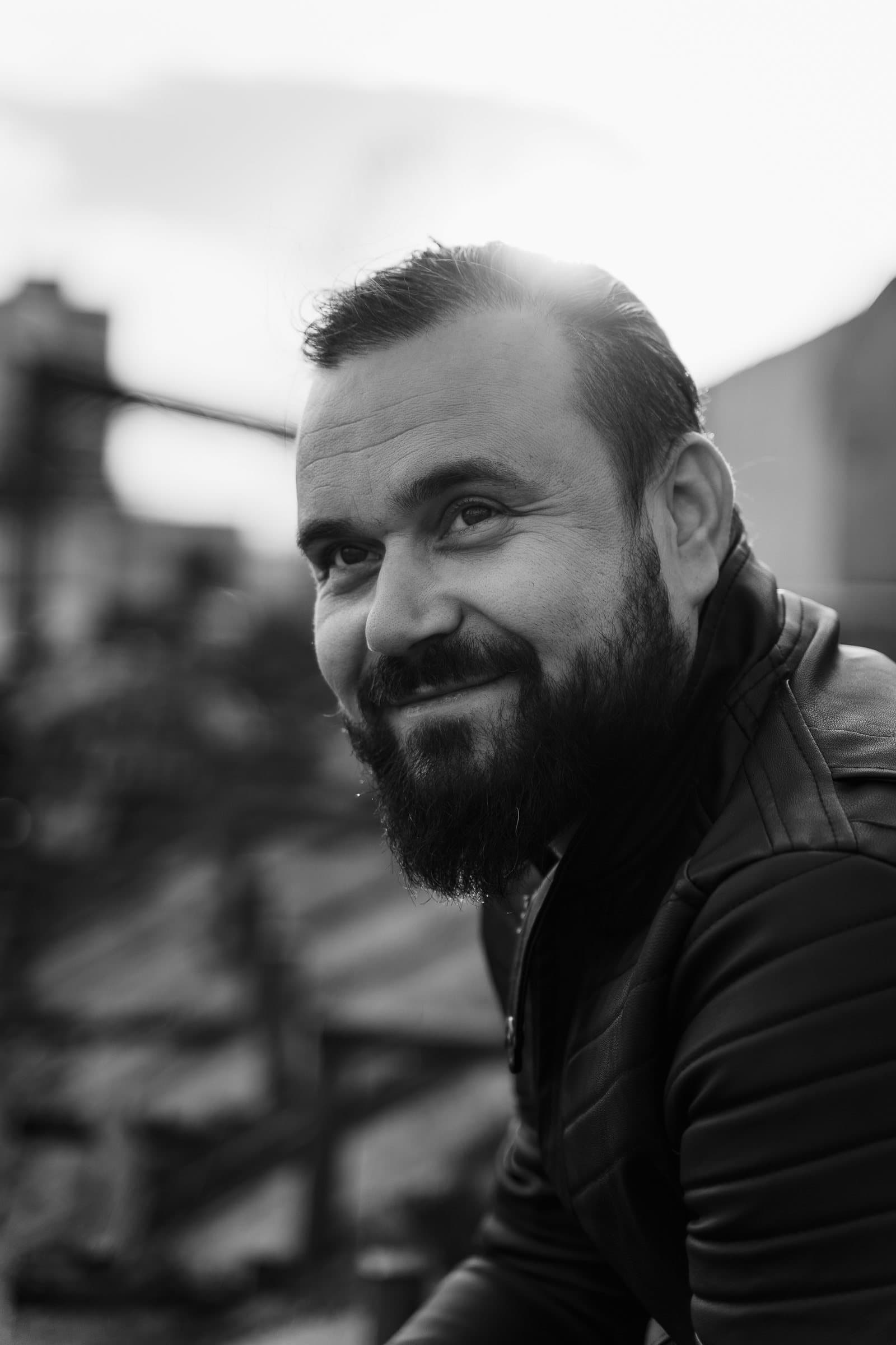 Black and white portrait of Bogdan, videographer, smiling
