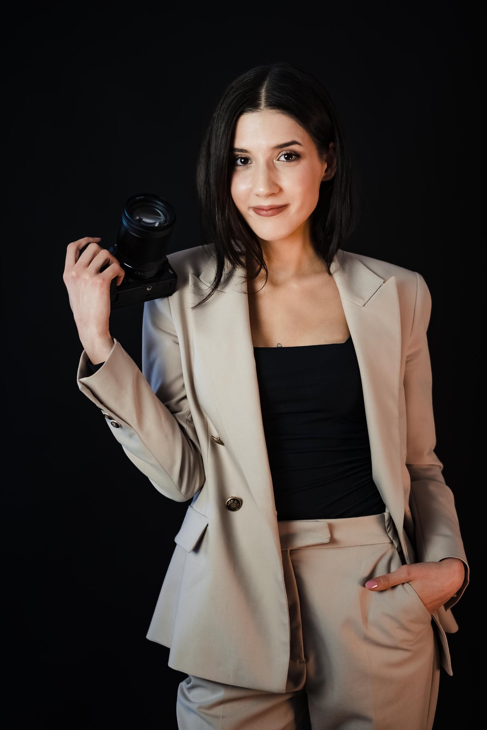 Portrait of Cătălina, lead photographer, holding her camera