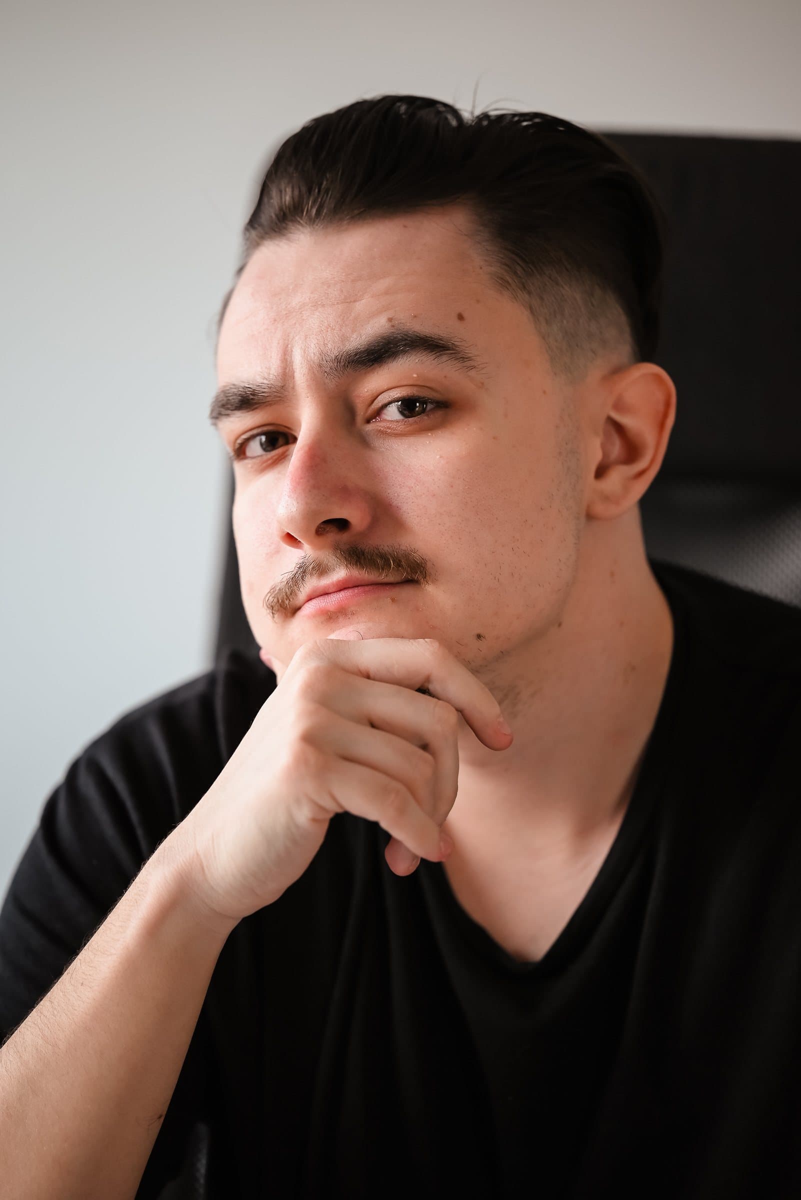 Portrait of Vali, second photographer, chin resting on his hand