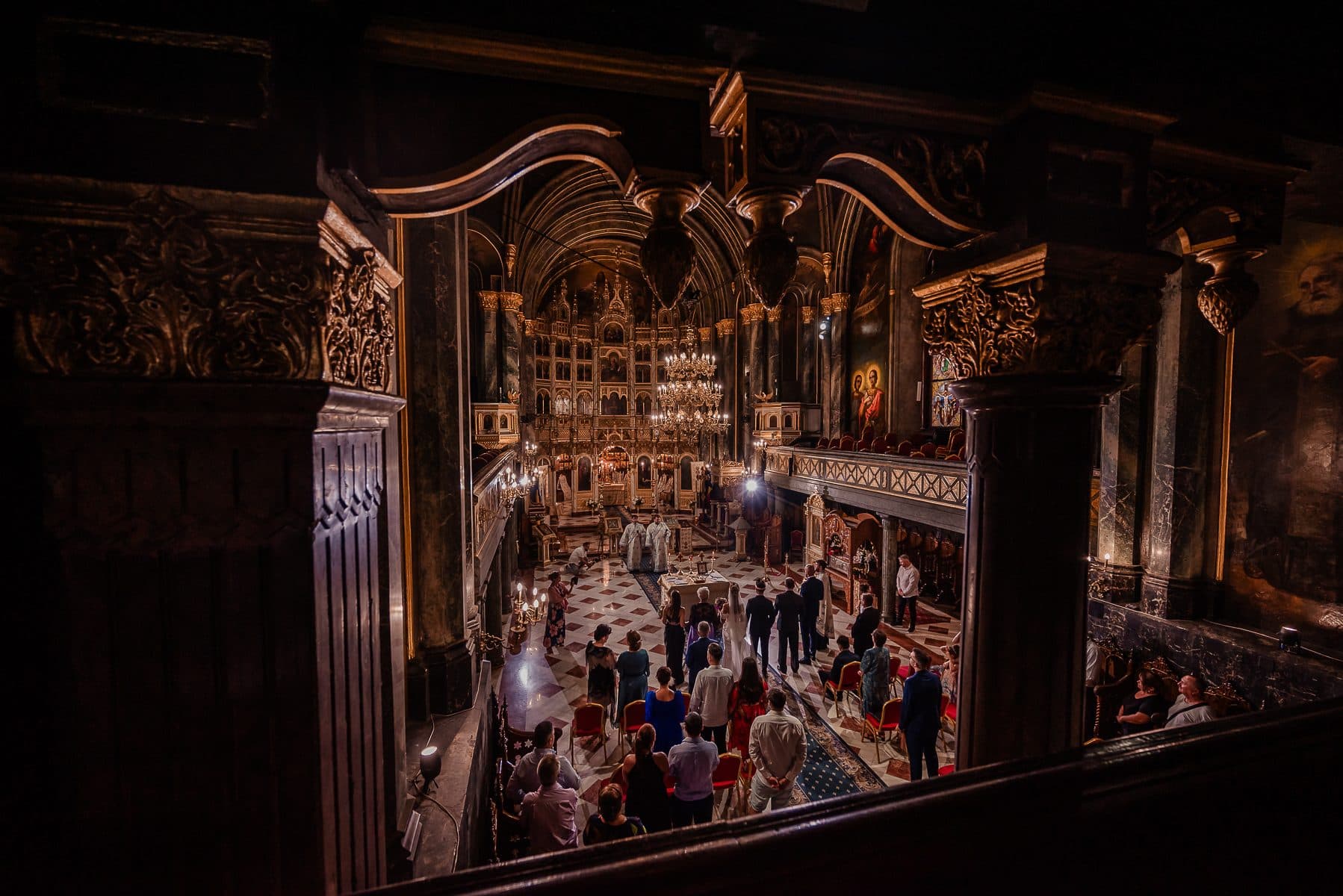 The cathedral seen from the balcony during the service, chandeliers lit