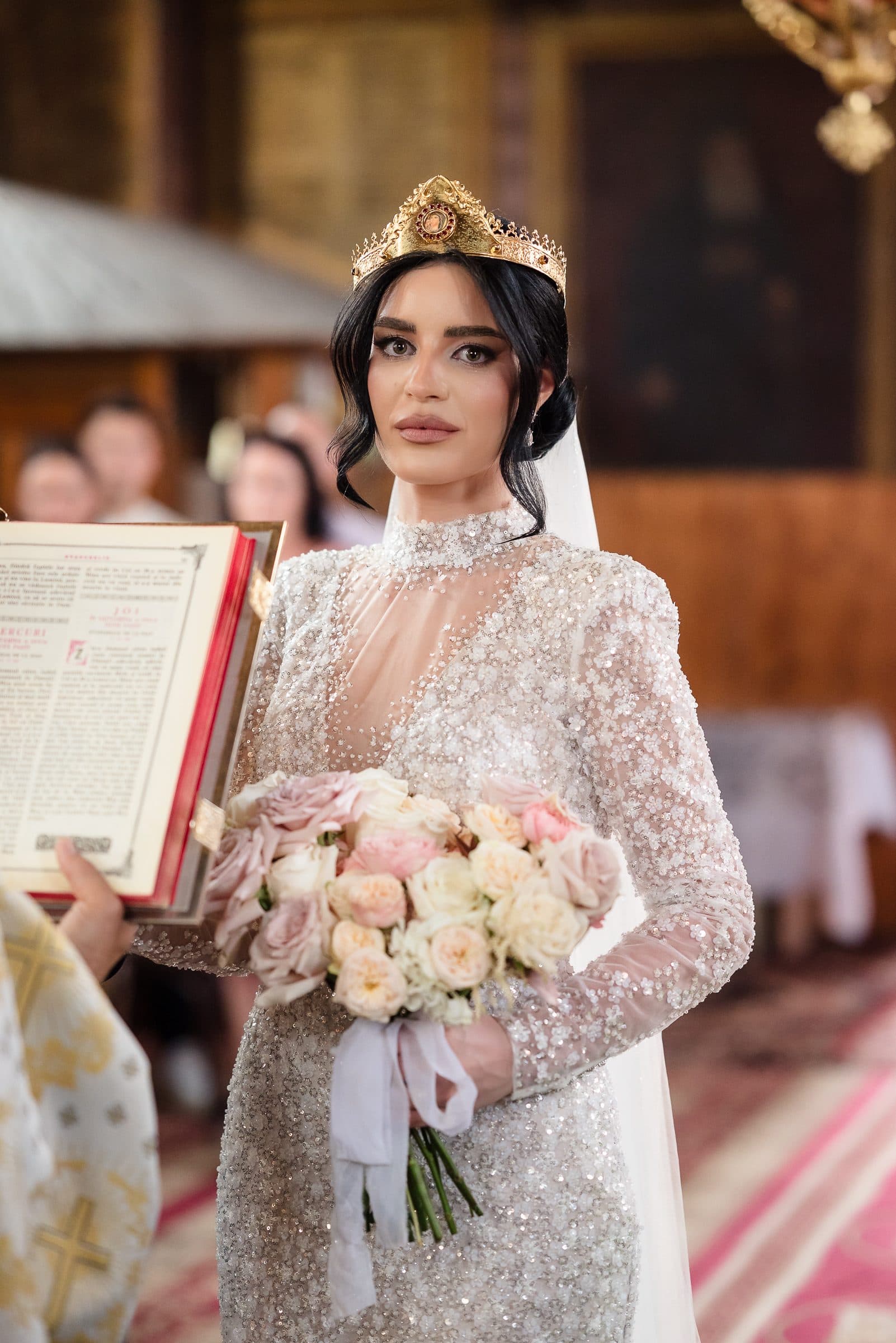 The bride in her wedding crown during the service, beside the open Gospel